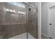 Walk-in shower with glass door and tiled walls at 308 Masden Rd, Holly Springs, NC 27540