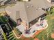 Aerial view featuring the roofline, brick exterior, and patio in landscaped yard at 310 Macallan, Burlington, NC 27215