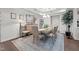 An elegant dining room features coffered ceilings, hardwood floors, and ample natural light at 310 Macallan, Burlington, NC 27215