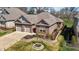 Elevated view of a brick home with manicured lawn and stone-lined garden at 310 Macallan, Burlington, NC 27215