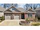 Beautiful brick home featuring an attached two-car garage and manicured landscaping at 310 Macallan, Burlington, NC 27215