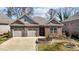 Lovely brick house featuring a two-car garage and meticulously maintained landscaping at 310 Macallan, Burlington, NC 27215