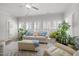 Bright living room filled with plants, a comfortable sofa, and lots of natural light at 310 Macallan, Burlington, NC 27215