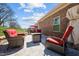 Relax on the brick patio with comfortable seating and an outdoor fire pit at 310 Macallan, Burlington, NC 27215