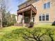 Backyard view of a deck overlooking a lush green lawn with a retaining wall at 314 Montelena Pl, Cary, NC 27513