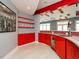 Stylish bar area with red cabinets, countertop, beverage fridge and beer tap at 314 Montelena Pl, Cary, NC 27513