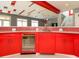 Stylish bar area with red cabinets, beverage fridge and beer tap at 314 Montelena Pl, Cary, NC 27513