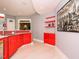 Stylish bar area with red cabinets, shelves and a large cityscape art piece at 314 Montelena Pl, Cary, NC 27513