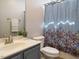 Bathroom featuring a vanity sink, toilet, and a shower with a vibrant patterned curtain at 314 Montelena Pl, Cary, NC 27513