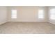 Bright, carpeted bedroom features two large windows, offering ample natural light at 314 Montelena Pl, Cary, NC 27513