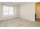 Bedroom featuring neutral walls, carpet floors, a window with natural light, and an open doorway at 314 Montelena Pl, Cary, NC 27513
