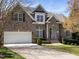 Charming two-story brick home with a well-manicured lawn and attached two-car garage at 314 Montelena Pl, Cary, NC 27513