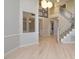 Open-concept living space featuring hardwood floors, a staircase, and stylish decor at 314 Montelena Pl, Cary, NC 27513
