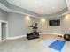 Spacious home gym featuring an elliptical machine, TV, yoga mats and ample room for activities at 314 Montelena Pl, Cary, NC 27513