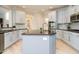Bright, modern kitchen features a large island and stainless steel appliances at 314 Montelena Pl, Cary, NC 27513
