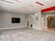 Large, carpeted living room with modern gray walls, custom ceiling design and mounted television at 314 Montelena Pl, Cary, NC 27513