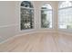 Bright living room featuring large windows and hardwood floors, offering plenty of natural light at 314 Montelena Pl, Cary, NC 27513