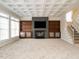 Expansive living room with fireplace, custom built-ins and coffered ceiling at 314 Montelena Pl, Cary, NC 27513