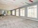 Large living room featuring gray walls, red ceiling accents, recessed lighting, and carpeted flooring at 314 Montelena Pl, Cary, NC 27513