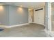 Spacious unfinished room with built-in shelving and white double doors at 314 Montelena Pl, Cary, NC 27513