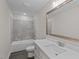 Bathroom with modern vanity, stylish mirror, and a tiled shower-tub combination at 316 Little Lady Trail, Zebulon, NC 27597