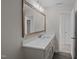Bathroom showcasing modern vanity with white countertop and an open doorway at 316 Little Lady Trail, Zebulon, NC 27597