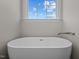 Close-up of a soaking tub with a window view of the sky at 316 Little Lady Trail, Zebulon, NC 27597