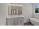 Bathroom with double vanity, quartz countertop, gold framed mirrors, and a soaking tub at 316 Little Lady Trail, Zebulon, NC 27597