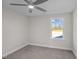 Bedroom with neutral carpet, ceiling fan, and a window with a pleasant view at 316 Little Lady Trail, Zebulon, NC 27597
