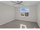 Neutral bedroom features plush carpet, ceiling fan, and a bright window at 316 Little Lady Trail, Zebulon, NC 27597