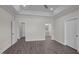 Bright bedroom with hard surface floors, tray ceiling, recessed lighting, and multiple doorways at 316 Little Lady Trail, Zebulon, NC 27597