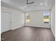 Bright bedroom with hard surface floors, tray ceiling, recessed lighting, and two windows at 316 Little Lady Trail, Zebulon, NC 27597