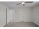 Bedroom with gray carpet, ceiling fan, and closet space at 316 Little Lady Trail, Zebulon, NC 27597