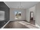 Open-concept dining area with a view, modern light fixture, and neutral wall paint at 316 Little Lady Trail, Zebulon, NC 27597