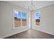 Bright room with two large windows providing ample natural light and hardwood floors at 316 Little Lady Trail, Zebulon, NC 27597