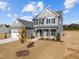 Charming two-story home featuring a gray exterior, black shutters, and a well-manicured lawn at 316 Little Lady Trail, Zebulon, NC 27597
