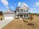 Beautiful home with a two-car garage, covered porch, manicured lawn, and gray color scheme at 316 Little Lady Trail, Zebulon, NC 27597