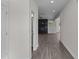 Hallway leading to a cozy living space with a fireplace, hardwood floors, and neutral paint at 316 Little Lady Trail, Zebulon, NC 27597