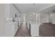 Modern kitchen featuring white cabinetry, stainless steel appliances, and a center island with pendant lighting at 316 Little Lady Trail, Zebulon, NC 27597