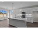 Bright kitchen featuring an island with stone countertops, pendant lights, and modern fixtures at 316 Little Lady Trail, Zebulon, NC 27597