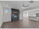 Spacious living room with hardwood floors, fireplace and a view into the modern kitchen at 316 Little Lady Trail, Zebulon, NC 27597