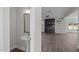 Hallway shot showcasing powder room with pedestal sink and a view into the living area at 316 Little Lady Trail, Zebulon, NC 27597