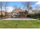 A house backyard featuring a pool and a well-manicured lawn at 3421 Griffice Mill Rd, Raleigh, NC 27610