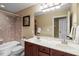 Bathroom with double sink vanity, shower, and decorative tile surround at 3421 Griffice Mill Rd, Raleigh, NC 27610