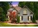 Charming two-story home featuring a lush landscaped yard, brick facade and inviting architectural details at 3421 Griffice Mill Rd, Raleigh, NC 27610