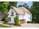 Exterior view of a home with a side-entry garage, manicured landscaping, and white siding at 3421 Griffice Mill Rd, Raleigh, NC 27610