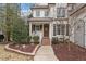 Inviting front porch with brick steps and a well-manicured landscape featuring mature trees and shrubbery at 3421 Griffice Mill Rd, Raleigh, NC 27610
