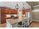 Gourmet kitchen with granite countertops, stainless steel appliances, and a large center island with seating at 3421 Griffice Mill Rd, Raleigh, NC 27610