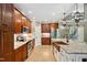 Modern kitchen with an island, stainless steel appliances, stone backsplash, and cherry cabinets at 3421 Griffice Mill Rd, Raleigh, NC 27610