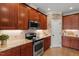Charming kitchen with granite countertops, stainless appliances, and exposed brick accents at 3421 Griffice Mill Rd, Raleigh, NC 27610